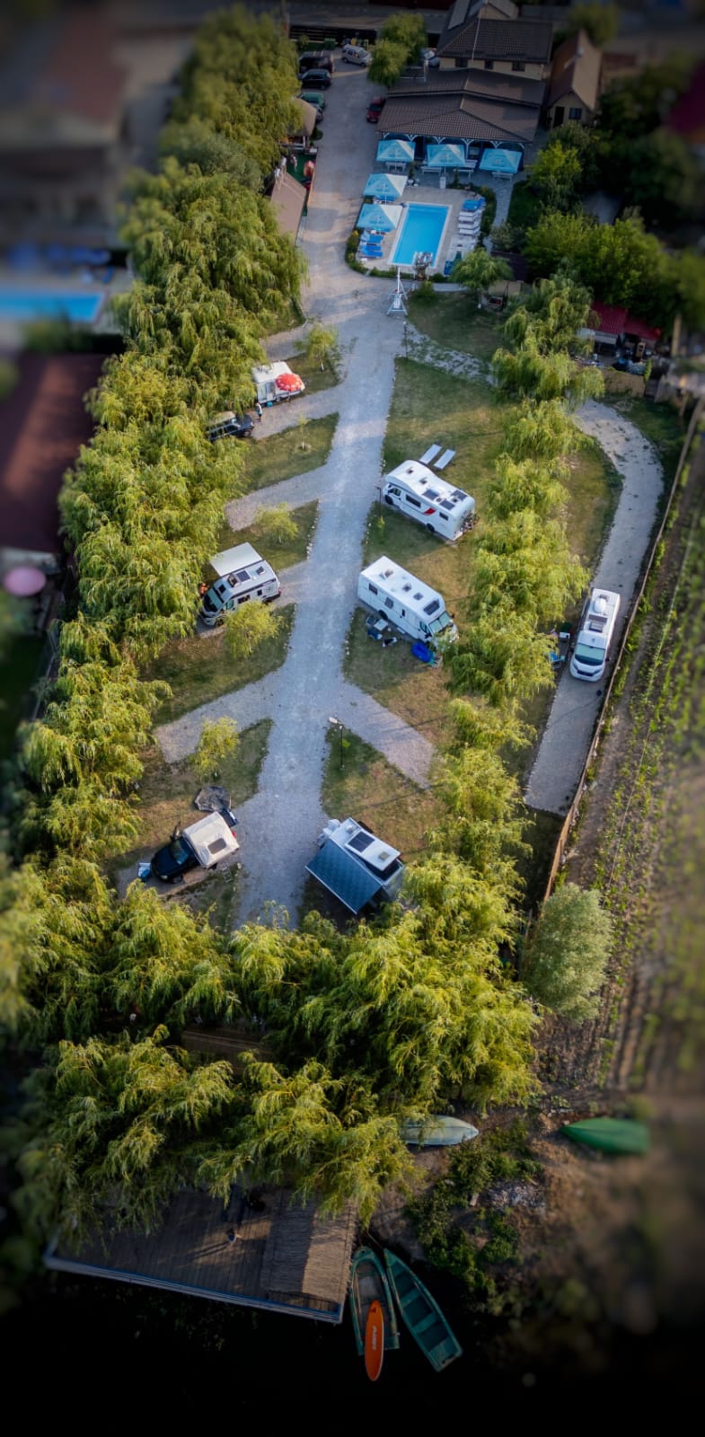 Aerial view of the camping pitches with motorhomes among the willows
